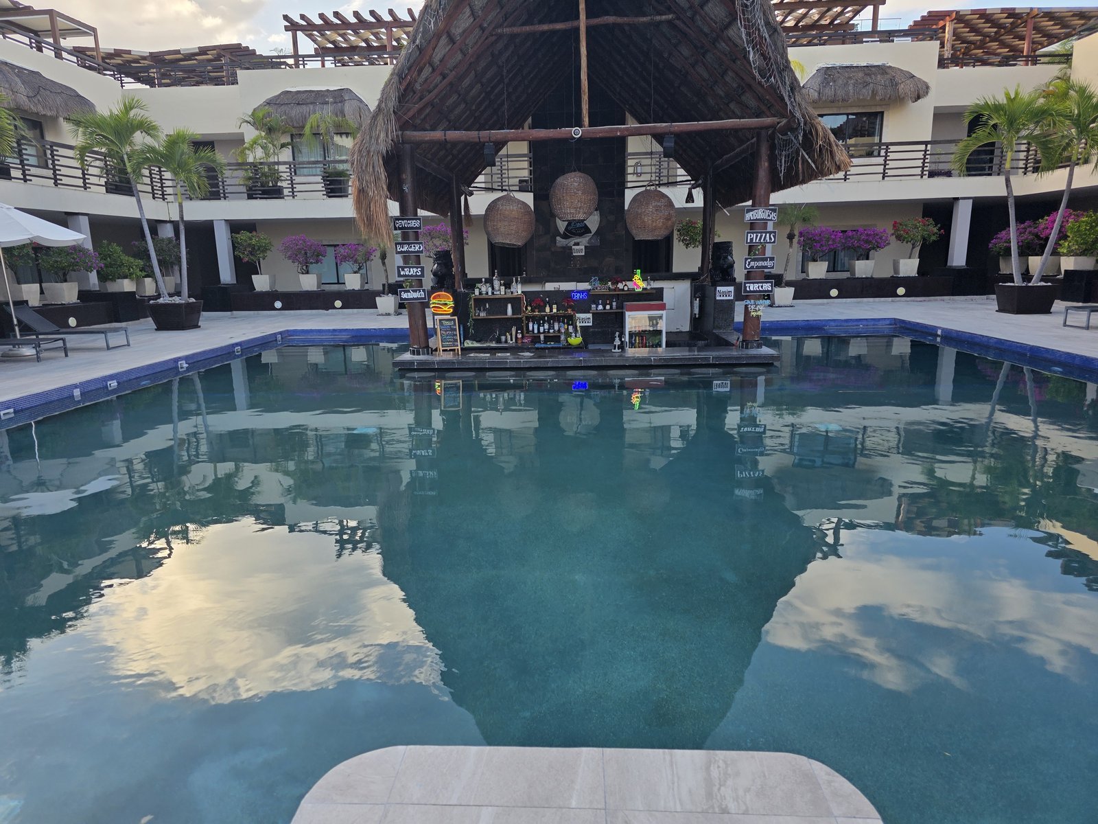 The resort pool at Aldea Thai, with a shallow end and a swim-up bar